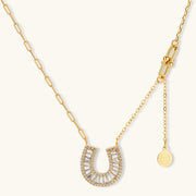 Stylish gold horseshoe jewelry set with polished finish, including earrings and necklace made by Astral Signature, perfect for any occasion.