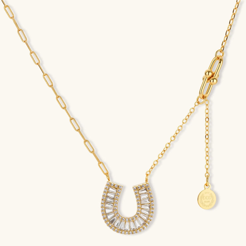 Stylish gold horseshoe jewelry set with polished finish, including earrings and necklace made by Astral Signature, perfect for any occasion.