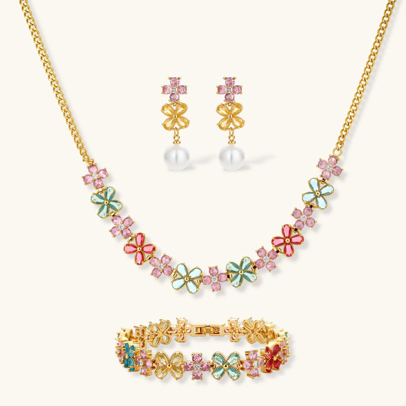 Garden Bloom Jewelry Set showcasing a three-piece collection including a floral pendant necklace, statement earrings, and a bracelet, designed by Astral Signature.