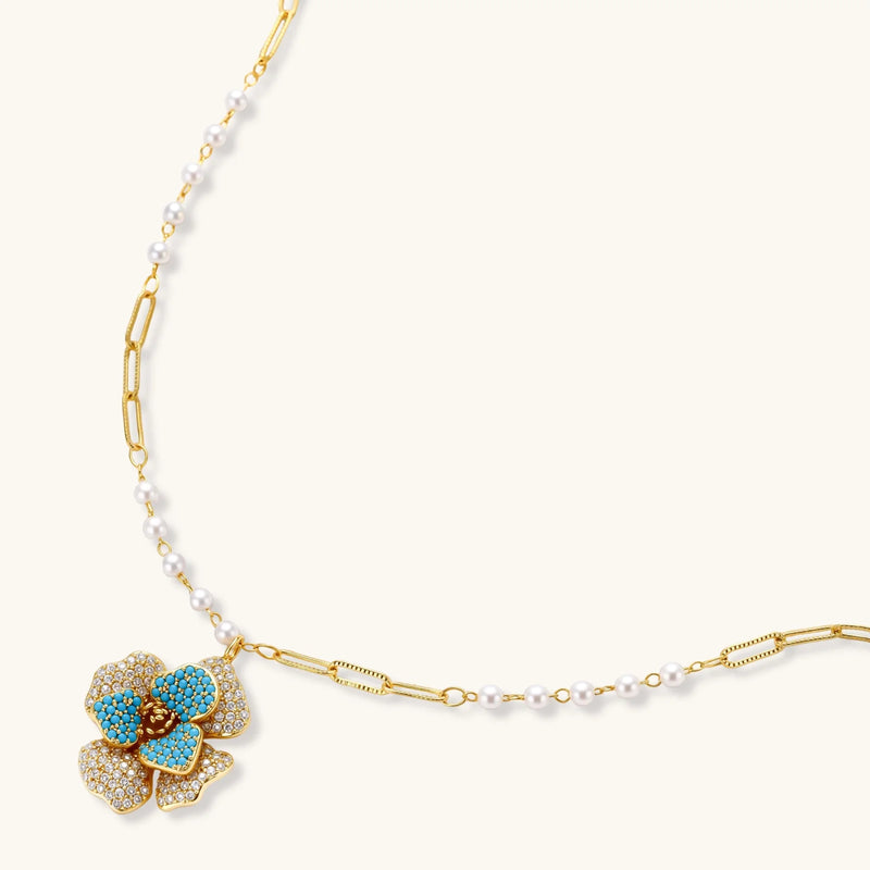 Close-up of the floral pendant necklace from the Blooming Elegance — Blue and Pearl Jewelry Set in 14K Gold by Astral Signature™, featuring pearl accents.