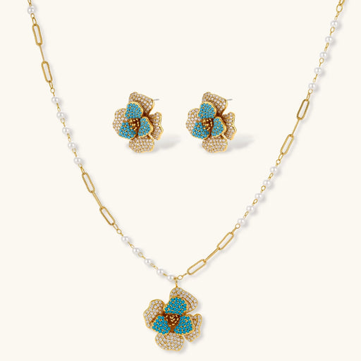 Blooming Elegance — Blue and Pearl Jewelry Set in 14K Gold by Astral Signature™ featuring a floral necklace and matching earrings with zirconia and pearl accents.
