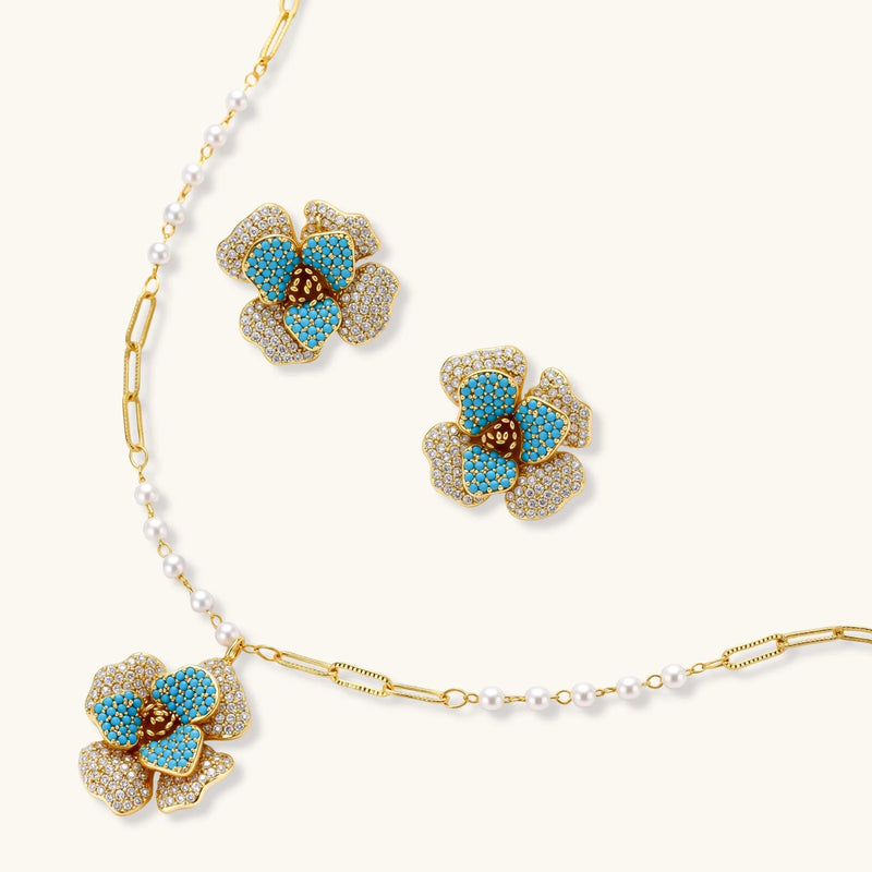 Blooming Elegance — Blue and Pearl Jewelry Set in 14K Gold by Astral Signature™, including detailed view of the floral necklace and earrings with blue zirconia.