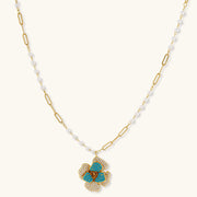 Blooming Elegance — Blue and Pearl Jewelry Set in 14K Gold by Astral Signature™, highlighting the elegant floral pendant of the necklace.