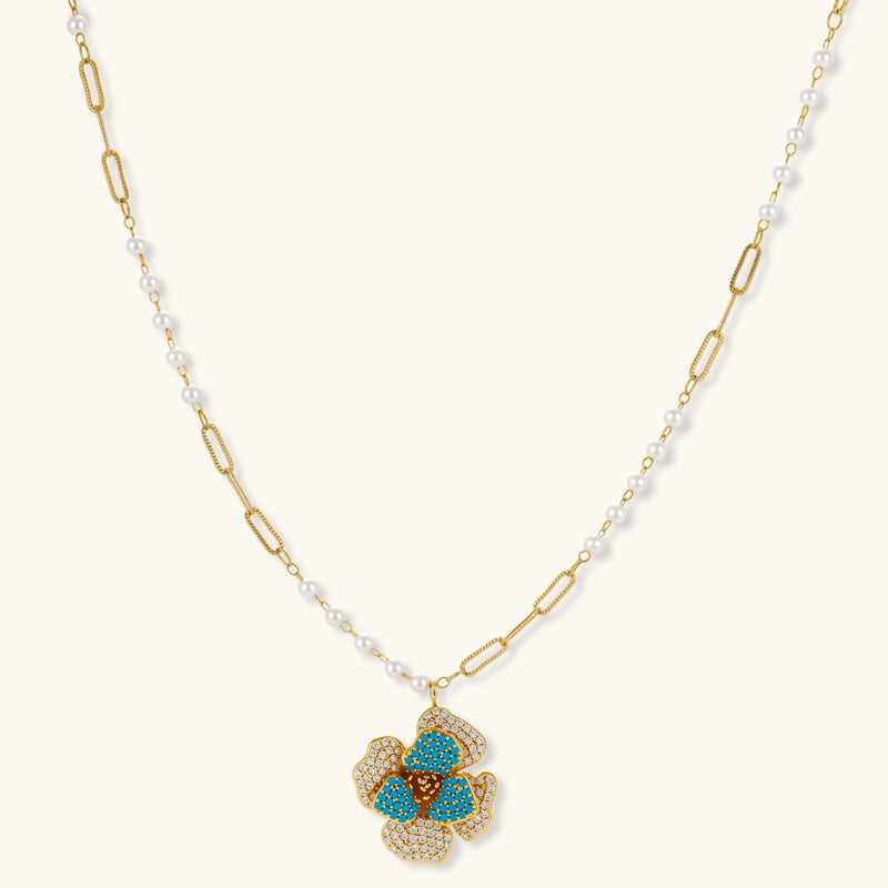 Blooming Elegance — Blue and Pearl Jewelry Set in 14K Gold by Astral Signature™, highlighting the elegant floral pendant of the necklace.