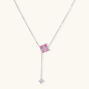 Detailed view of the Pink Prism Cross Set from Astral Signature, featuring a geometric cross pendant with pink zirconia stones.