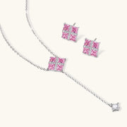 Close-up of the Pink Prism Cross Set by Astral Signature, highlighting the cross pendant necklace and earrings adorned with pink zirconia.