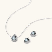 Close-up of the Sphere Luxe Set by Astral Signature, displaying an exquisite silver necklace and earrings with a unique sphere design enhanced by sparkling zirconia.