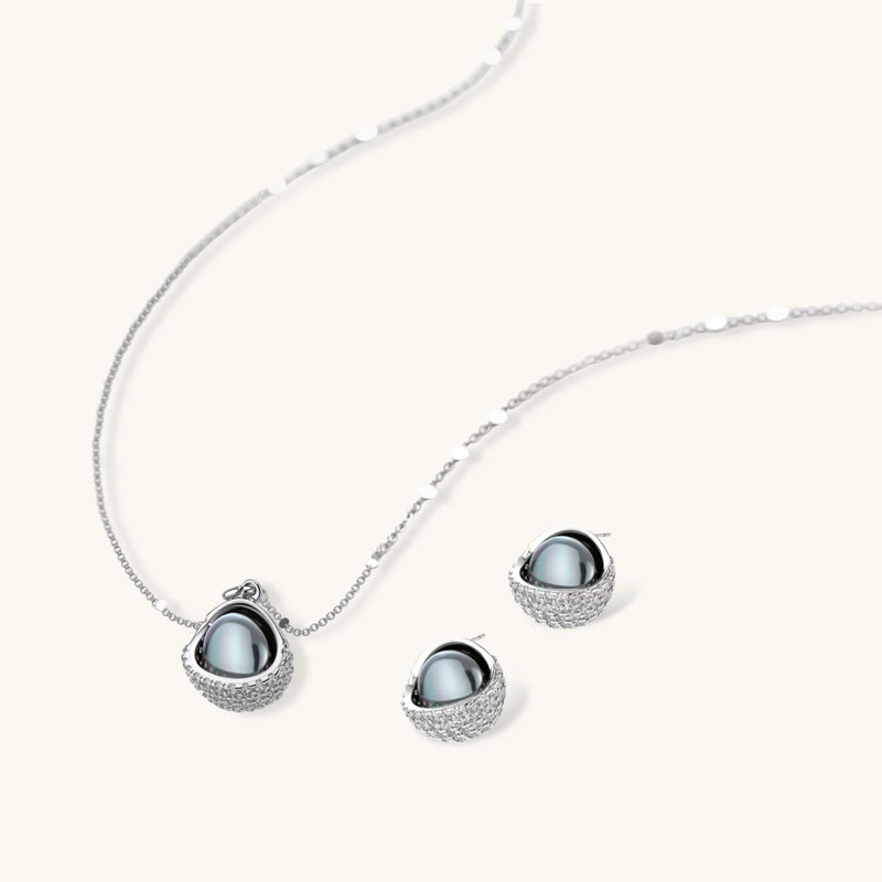Close-up of the Sphere Luxe Set by Astral Signature, displaying an exquisite silver necklace and earrings with a unique sphere design enhanced by sparkling zirconia.