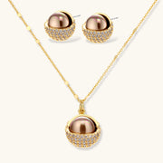 Sphere Luxe Set in gold by Astral Signature, consisting of a luxurious gold necklace and matching earrings with a radiant sphere design and zirconia accents.
