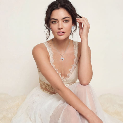 Model wearing the Crystal H Initial Set Necklace and Earrings by Astral Signature, elegantly styled with a lace attire.