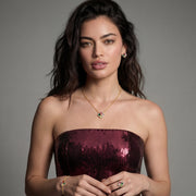 A model wearing the Lucky Clover Jewelry Set Astral Signature™ Edit, featuring a gold-plated necklace, earrings, and bracelet, beautifully styled for an elegant look.