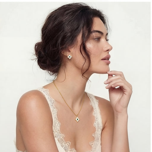 Model showcasing the Emerald Radiance — 14K Gold Plated Emerald Zirconia Jewelry Set by Astral Signature, wearing the necklace and earrings that exemplify a sophisticated Emerald Jewelry Set. This stunning 14K Gold Plated Jewelry Set enhances the wearer's elegance, making a chic addition to any Jewelry Set.