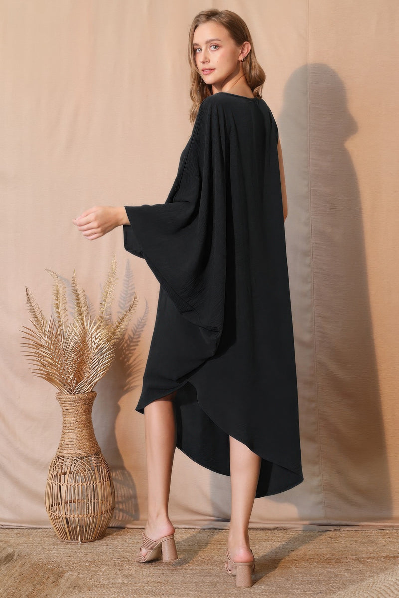 Back view of the Matte Crepe One Sleeve Dress by TYCHE, demonstrating its elegant silhouette and modern style. This dress in black is perfect for any event and is part of NEW ARRIVALS. Great for gifting, it's an essential in Women's Clothing. APPAREL, Black, CCPRODUCTS, DRESSES, Gift for Her, One Sleeve Dress, Women's, Women's top.