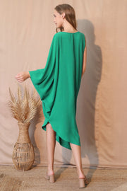 A rear view of the TYCHE Matte Crepe One Sleeve Dress in eye-catching green, emphasizing its stylish drape and minimalist design. This piece fits within APPAREL, CCPRODUCTS, Dress, DRESSES, Green, Matte Crepe One Sleeve Dress, NEW ARRIVALS, One Sleeve Dress, Women's Clothing.