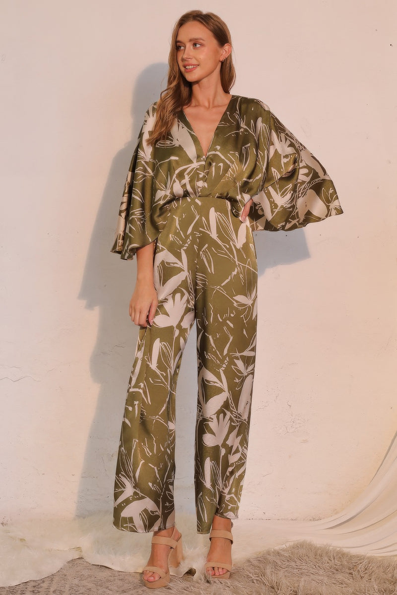 Astral Women's Jumpsuit - Olive Bloom Floral Satin Cape showcases a chic silhouette with wide-leg design and graceful cape detail, designed by TYCHE. A perfect choice for women who love elegant fashion. APPAREL, CCPRODUCTS, JUMPSUITS & ROMPERS, NEW ARRIVALS, Olive, Satin Cape, Women's Clothing, Women's Jumpsuit, Women’s.