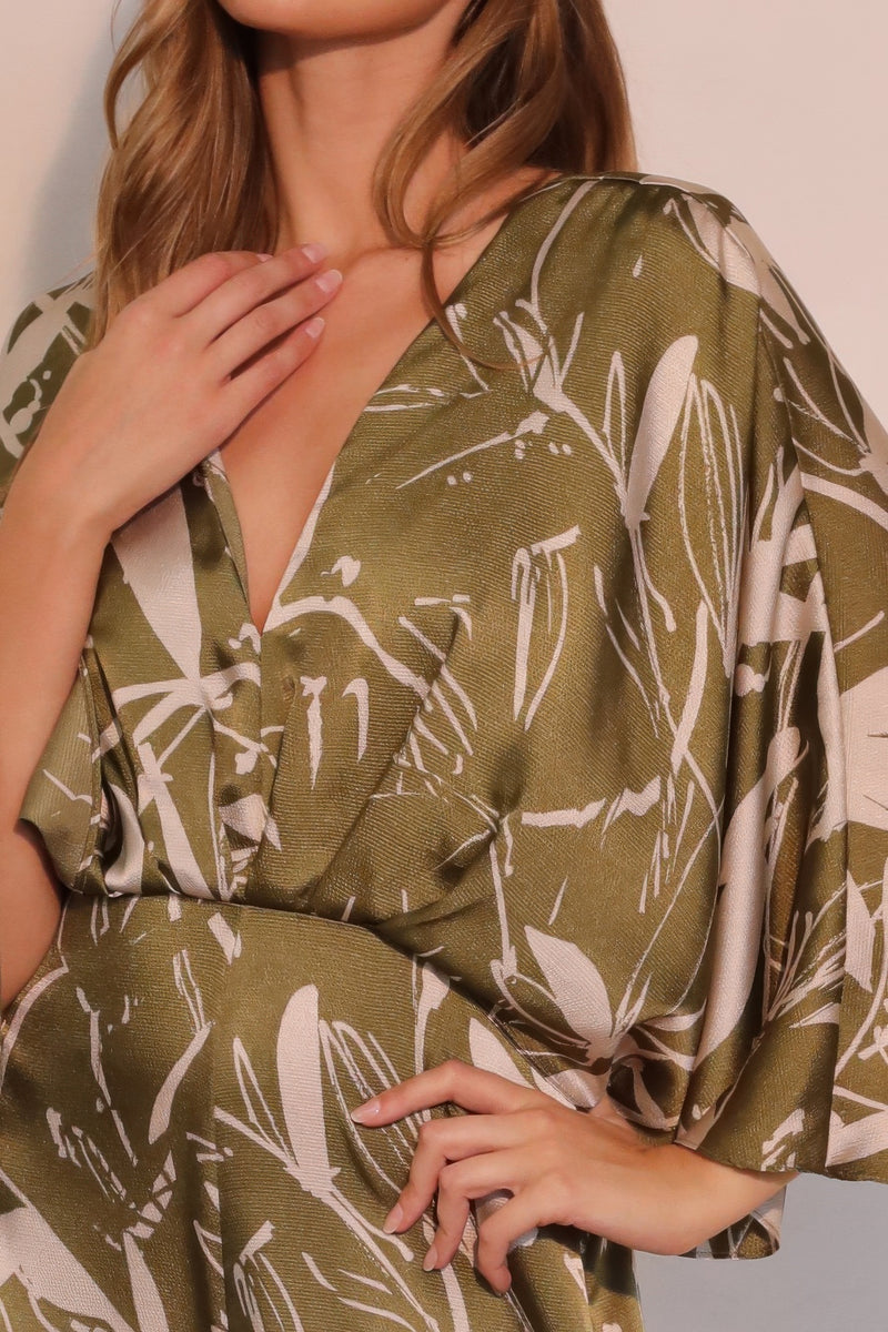 Close-up of the fabric and design of Astral Women's Jumpsuit - Olive Bloom Floral Satin Cape, highlighting its luxurious satin texture and intricate detailing. A standout piece from TYCHE, perfect for fashionable women. APPAREL, CCPRODUCTS, JUMPSUITS & ROMPERS, NEW ARRIVALS, Olive, Satin Cape, Women's Clothing, Women's Jumpsuit, Women’s.