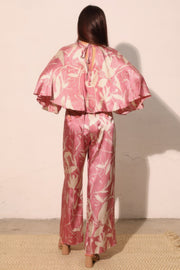 Back view of the Astral Women's Jumpsuit - Dreaming Lily Satin Cape by TYCHE, presenting a stunning cape silhouette that enhances movement and style, perfect for evening wear. This Women's Jumpsuit is an essential piece for refined women's clothing collections. APPAREL, CCPRODUCTS, JUMPSUITS & ROMPERS, NEW ARRIVALS, Pink, Women's, Women's Clothing, Women's Style.