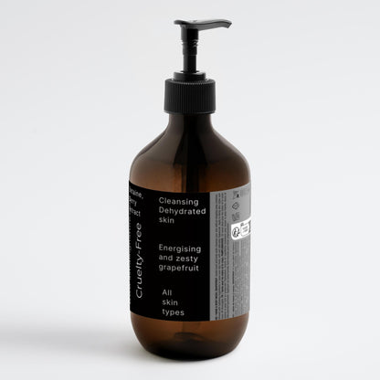 Astral Signature™ Hand & Body Wash Cleanses, Grapefruit in a minimalist amber bottle, suitable for all skin types. Formulated with Betaine, this hydrating body wash effectively cleanses dehydrated skin. A premium option for body-care, it combines gentle cleansing with a refreshing grapefruit scent while remaining vegan.