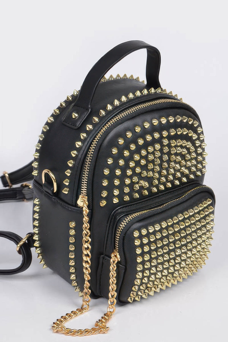 Side view of the Studded Backpack with Chain Zipper by HD ACCESSORIES showcasing its striking black and gold studded exterior. This handbag is part of the new arrivals, ideal for anyone looking for eye-catching accessories.