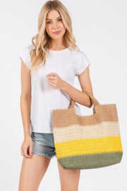 A model showcasing the Weekender Stripe Tote Bag by HD ACCESSORIES, featuring a chic design in mustard and green shades. This versatile beach tote bag is perfect for daily errands or weekend getaways. With its spacious interior and vibrant palette, this tote bag is a sweet addition to your summer collection. The Weekender Stripe Tote Bag is part of the latest arrivals in the accessories line.