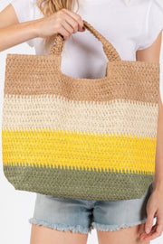 A close-up view of the Weekender Stripe Tote Bag by HD ACCESSORIES, displaying vibrant stripes in yellow, beige, and green. This beach tote bag blends style with practicality, making it an ideal choice for daily use or vacationing. Embrace the summer vibe with the Weekender Stripe Tote Bag, a trendy addition from the new arrivals line of accessories.