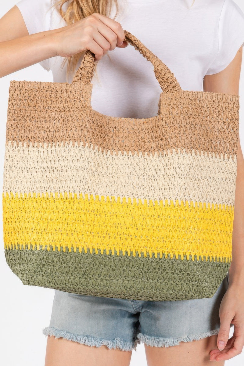 A close-up view of the Weekender Stripe Tote Bag by HD ACCESSORIES, displaying vibrant stripes in yellow, beige, and green. This beach tote bag blends style with practicality, making it an ideal choice for daily use or vacationing. Embrace the summer vibe with the Weekender Stripe Tote Bag, a trendy addition from the new arrivals line of accessories.