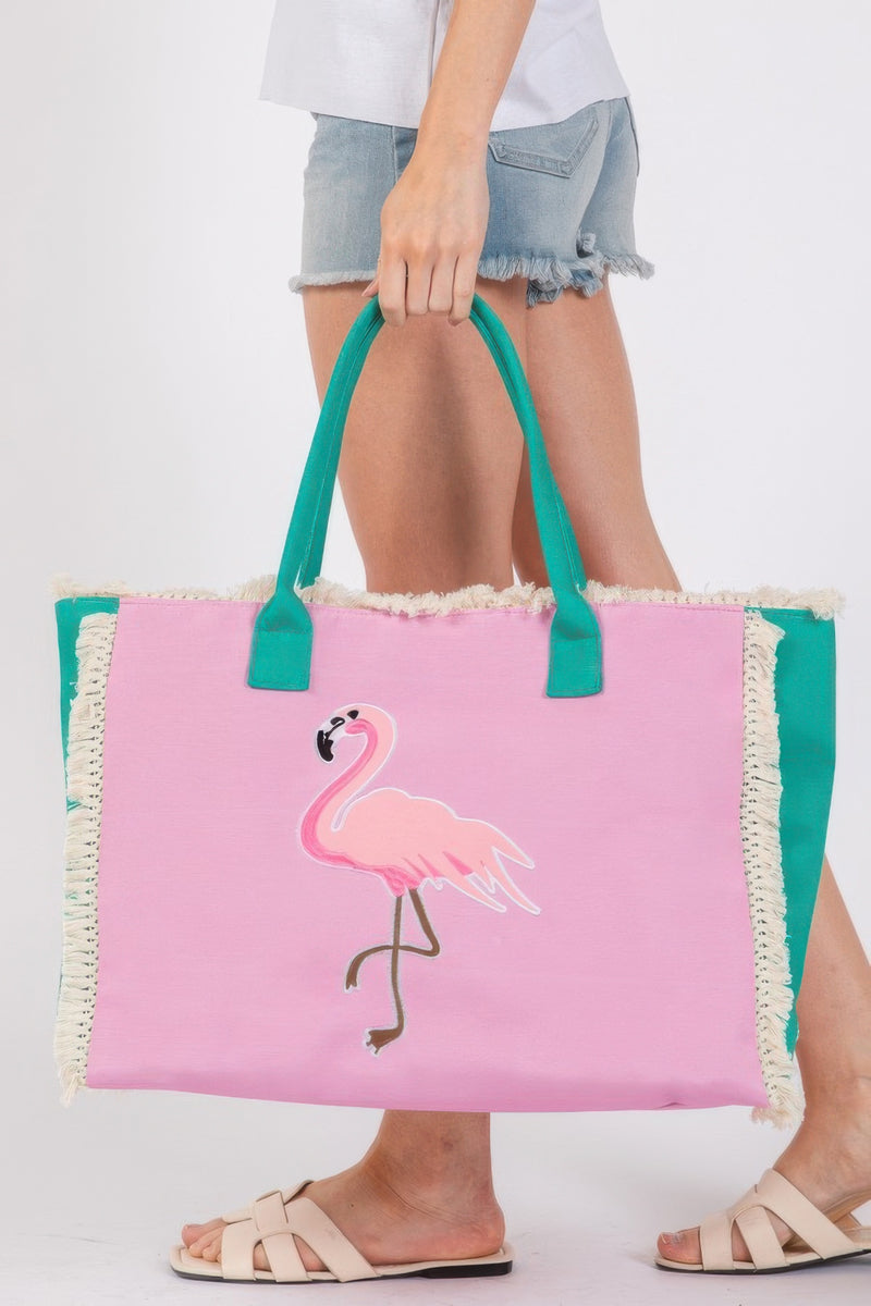 Flamingo design on a vibrant pink Handle Beach Tote Bag by HD ACCESSORIES, showcasing playful fringe and perfect for summer adventures. This unique accessory is part of the NEW ARRIVALS collection and features elements of Flamingos, ideal for beach outings. Embrace style with this Handle Beach Tote Bag, combining fashion and functionality.