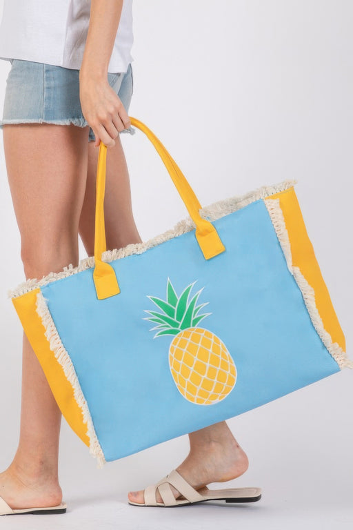 Bright blue Handle Beach Tote Bag by HD ACCESSORIES, adorned with a Pineapple embroidery and stylish fringe trim. This fashionable bag is perfect for casual outings and beach trips. An essential from the NEW ARRIVALS collection, the Handle Beach Tote Bag uniquely represents summer fun with its vibrant colors and eye-catching Pineapple design.