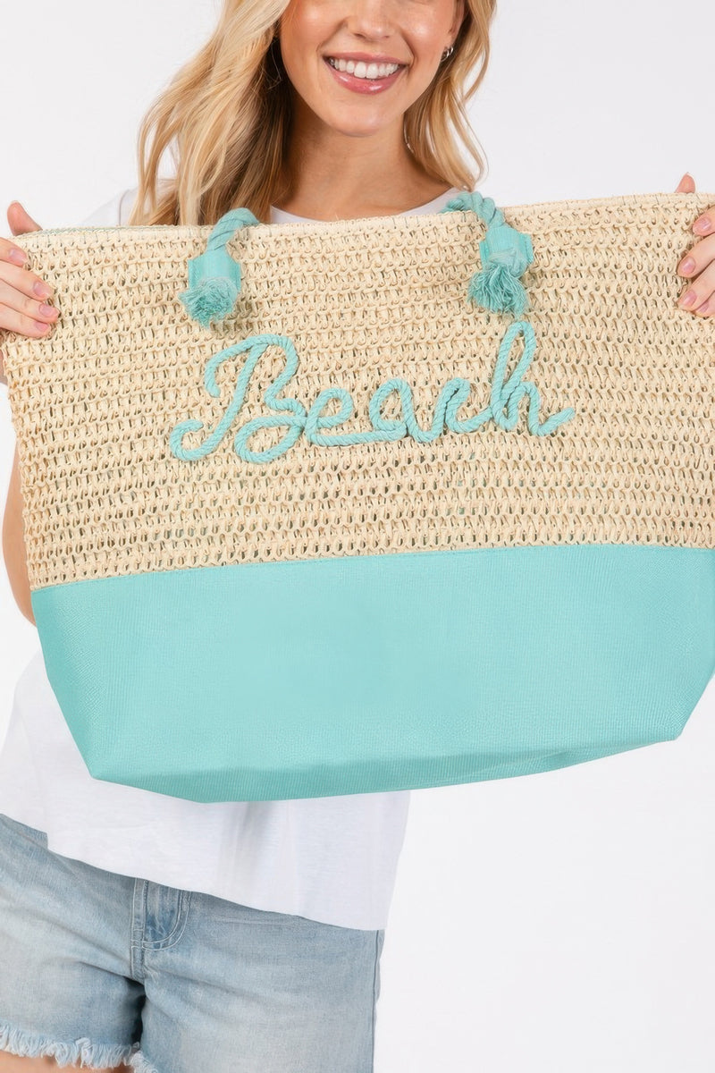 A close-up of the Rope Handle Beach Tote featuring the name 'Beach' beautifully crocheted in contrasting Turquoise. This innovative Tote Bag by HD ACCESSORIES is not only functional for summer activities but also a fashion statement available in various colors including vibrant Yellow and Navy.