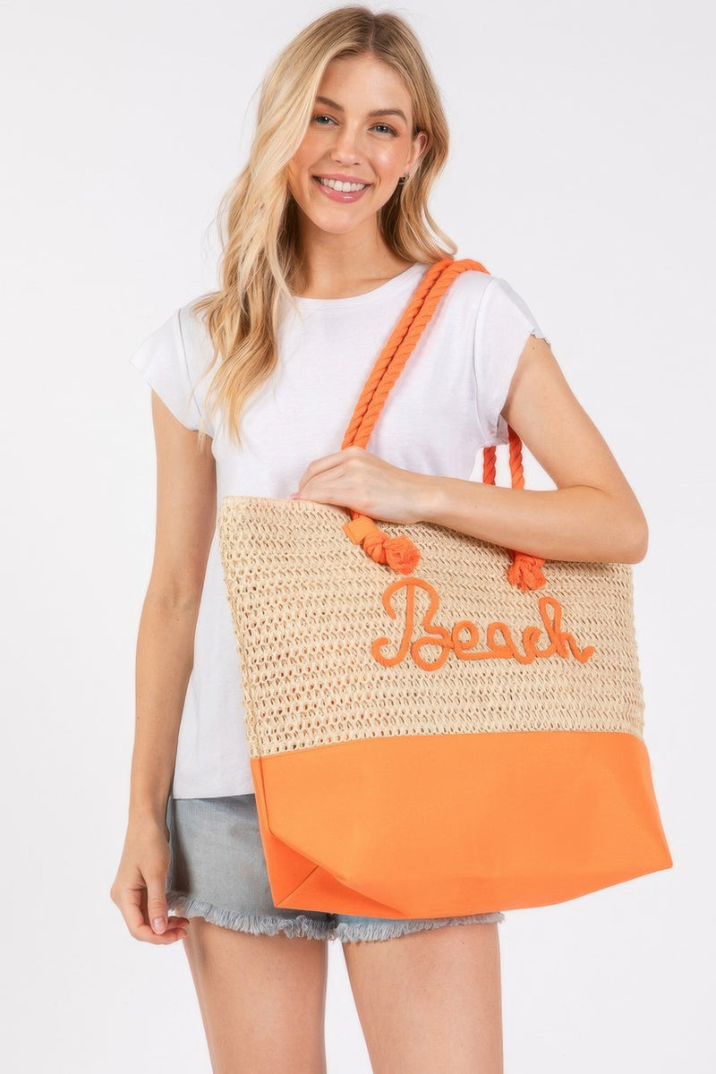 A summer-ready model displays the Rope Handle Beach Tote from HD ACCESSORIES in a bright Orange shade, perfect for beach outings. The crochet and 'Beach' lettering add style and chicness to this essential Beach Tote Bag, among the latest NEW ARRIVALS highlighting bold colors like Green and Hot Pink.