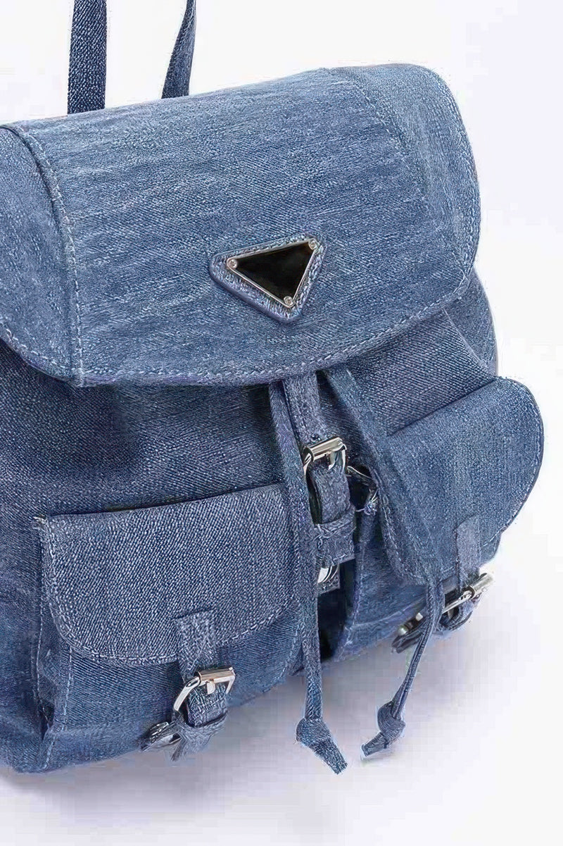 Detailed view of the medium blue denim double pocket front backpack by HD ACCESSORIES, highlighting its structural design and practical features. This Backpack, perfect for everyday carry, combines the look of a bag and the functionality of an accessory. Ideal for casual outings and a must-have from our NEW ARRIVALS.