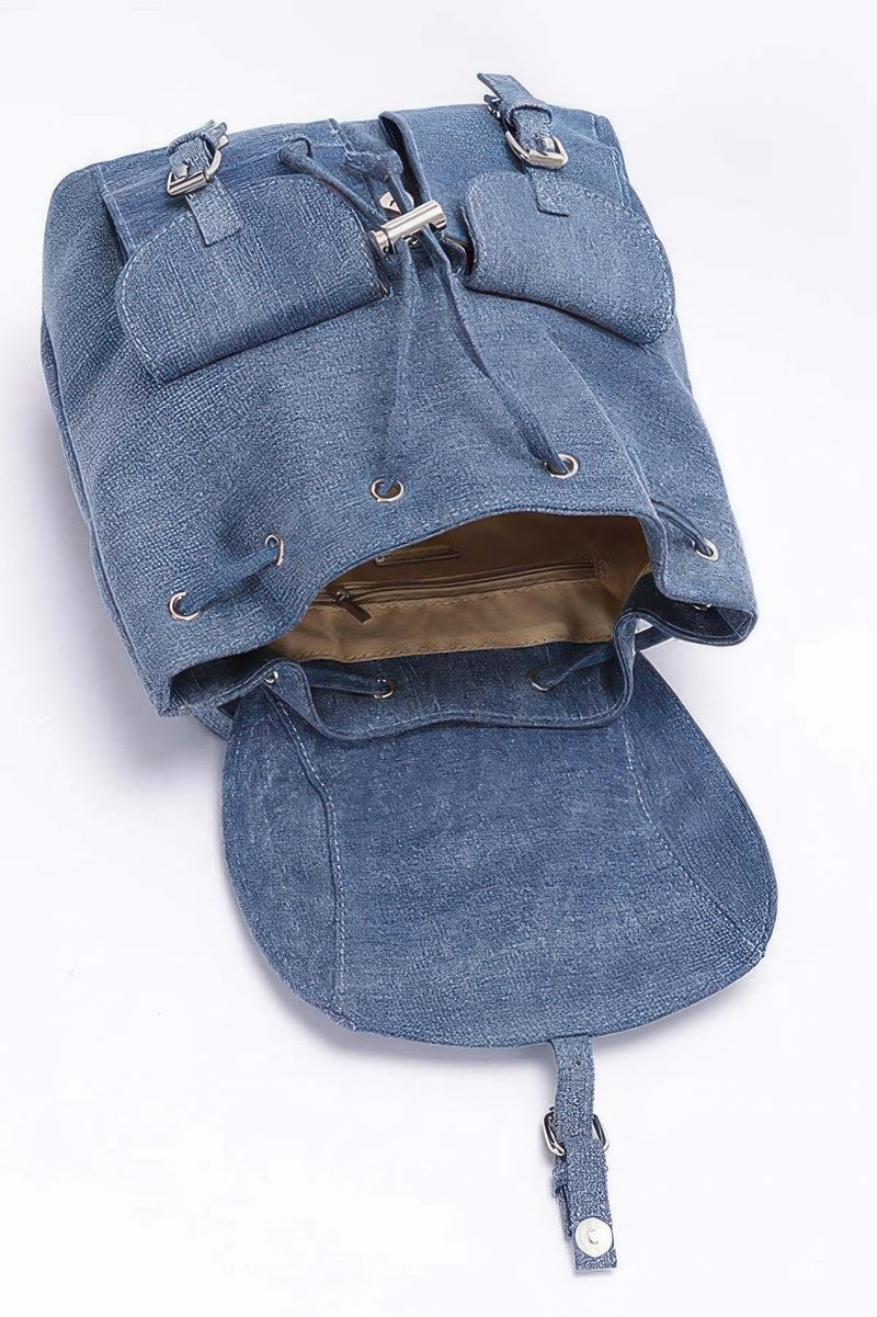 Inside view of the medium blue denim double pocket front backpack by HD ACCESSORIES, showing the spacious interior and practical features. This Backpack offers a secure snap closure, making it a convenient bag for everyday use and an excellent accessory choice among our NEW ARRIVALS.