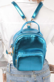 Model showcasing a blue metallic backpack from HD ACCESSORIES, featuring adjustable straps for a personalized fit. This stylish Backpack complements casual outfits and is an essential addition to your #ACCESSORIES wardrobe.