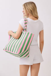 A woman holding a green striped Beach Tote Bag - Striped Tote Bags from HD ACCESSORIES, emphasizing its large capacity and comfortable design. Ideal for casual outings, this bag comes in various colors including Pink green and Yellow, listed under NEW ARRIVALS.