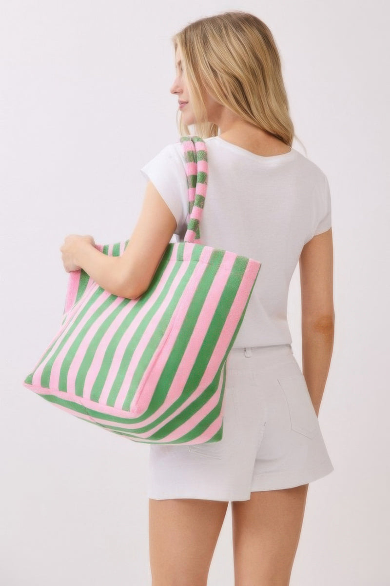 A woman holding a green striped Beach Tote Bag - Striped Tote Bags from HD ACCESSORIES, emphasizing its large capacity and comfortable design. Ideal for casual outings, this bag comes in various colors including Pink green and Yellow, listed under NEW ARRIVALS.