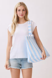 A woman holding a blue striped Beach Tote Bag - Striped Tote Bags from HD ACCESSORIES, emphasizing lightweight comfort and chic style. This versatile accessory is available in shades like Green, Pink green, and Yellow for all your casual needs.