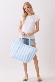 A woman posing with a pink and gray striped Beach Tote Bag - Striped Tote Bags from HD ACCESSORIES, showcasing its spacious design. Ideal for daily errands, this stylish tote is available in various colors including Orange and Green, featured in ACCESSORIES.