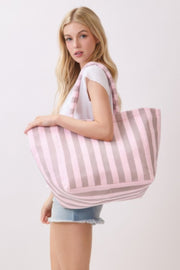 A woman confidently carrying a yellow striped Beach Tote Bag - Striped Tote Bags from HD ACCESSORIES, emphasizing its spacious and stylish design. Ideal for everyday outings, this bag is available in a variety of colors including Pink green and Orange.