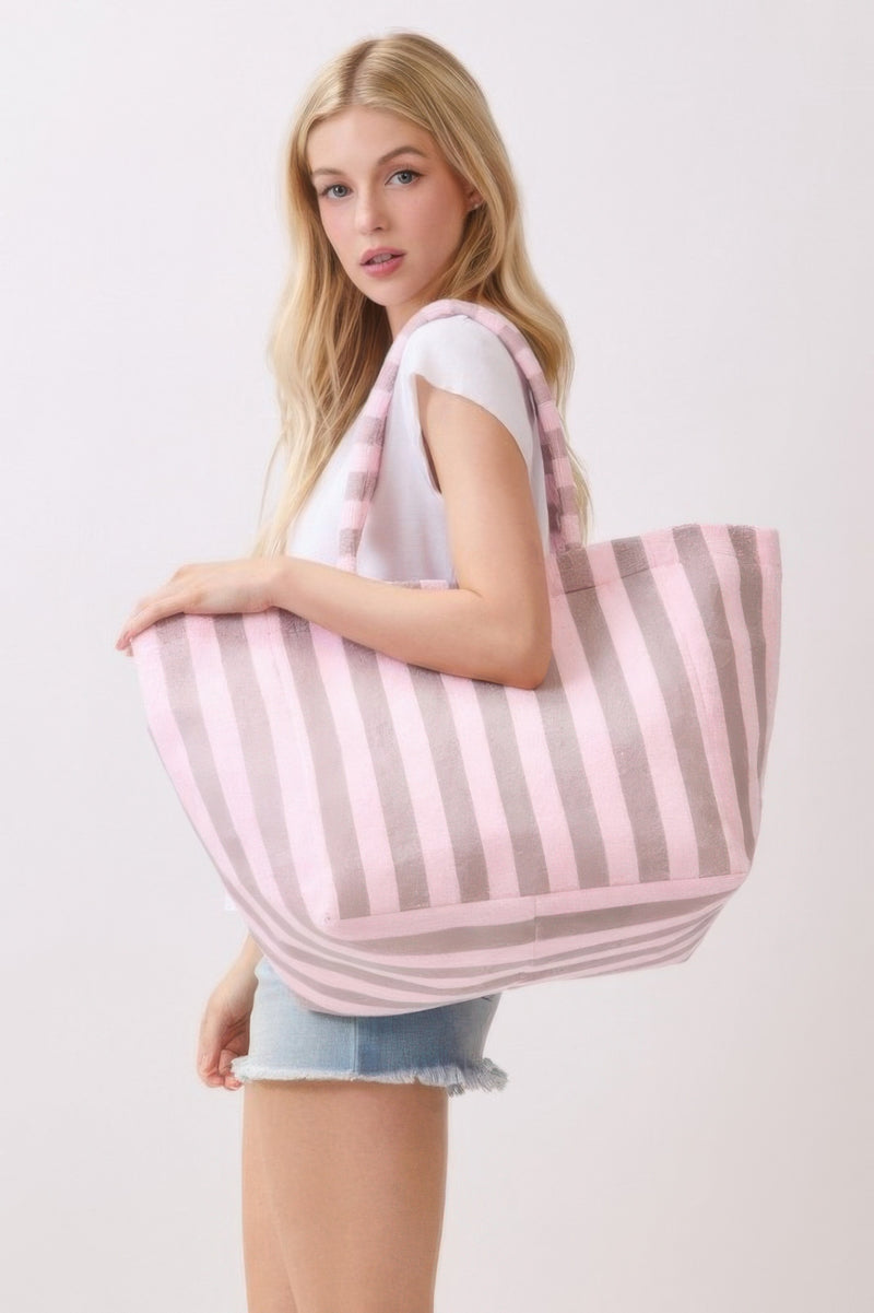A woman confidently carrying a yellow striped Beach Tote Bag - Striped Tote Bags from HD ACCESSORIES, emphasizing its spacious and stylish design. Ideal for everyday outings, this bag is available in a variety of colors including Pink green and Orange.