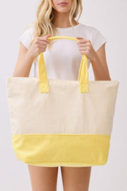 Model proudly presenting the Beach Tote Bag in Yellow from HD ACCESSORIES, highlighting its lemony theme and spacious interior, perfect for summer fun. This item is among the newest arrivals.