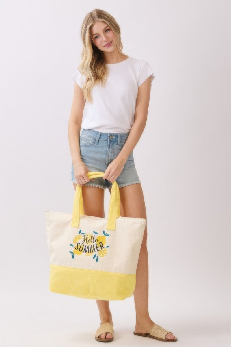 Model showcases the Beach Tote Bag in Yellow by HD ACCESSORIES, designed with a cheerful 'Hello Summer' graphic, perfect for beach outings and casual brunches. This piece is a trendy new arrival.