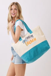 Another angle of the Beach Tote Bag in Blue from HD ACCESSORIES, held by a smiling model. Showcasing the cheerful palm tree and wave graphic with 'Take Me To The Beach,' this tote bag is an essential for sunny days. The stylish Beach Tote Bag in Blue offers ample space for beach essentials and an eye-catching design suitable for all occasions. Discover the latest in the NEW ARRIVALS at Astral Signature.
