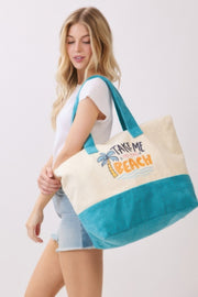 Close-up of a model with the Beach Tote Bag in Blue by HD ACCESSORIES, highlighting the playful graphics and spacious design. This Beach Tote Bag in Blue features a soft texture and is perfect for carrying all your summer essentials, embodying a fun and relaxed vibe. Perfect for beach days, picnics, or daily essentials, this tote is a versatile accessory from the HANDBAGS collection.
