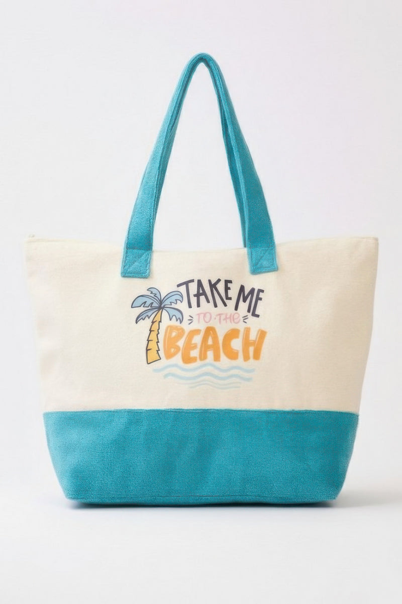 Beach Tote Bag in Blue from HD ACCESSORIES, featuring playful palm tree and wave graphic with the slogan 'Take Me To The Beach' on a canvas designed for summer outings. Perfect for beach trips, this Beach Tote Bag in Blue offers a spacious interior and a stylish look. Ideal for light summer essentials, this tote is part of the NEW ARRIVALS by Astral Signature, combining fashion with function. Suitable for all casual outings, including picnics and trips to the park.