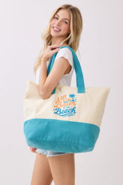 Woman modeling the Beach Tote Bag in Blue - Life Is Better At The Beach by HD ACCESSORIES, displaying its stylish look and graphic design. Perfect for beach trips, included in ACCESSORIES, Beach Tote Bag, Blue, CCPRODUCTS, HANDBAGS, NEW ARRIVALS, Tote Bag.