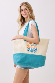 Side view of the Beach Tote Bag in Blue - Life Is Better At The Beach from HD ACCESSORIES, emphasizing its casual style and uplifting slogan. An ideal choice for summer activities, included in ACCESSORIES, Beach Tote Bag, Blue, CCPRODUCTS, HANDBAGS, NEW ARRIVALS, Tote Bag.