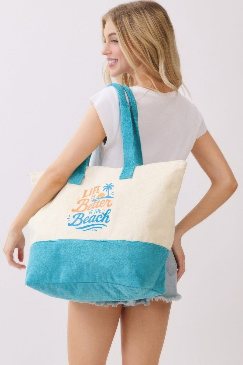 Model holding the Beach Tote Bag in Blue - Life Is Better At The Beach by HD ACCESSORIES, featuring a sleek design that enhances any casual look. Categorized under ACCESSORIES, Beach Tote Bag, Blue, CCPRODUCTS, HANDBAGS, NEW ARRIVALS, Tote Bag.