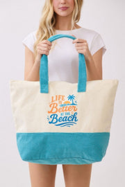 Model in a casual setting with the Beach Tote Bag in Blue - Life Is Better At The Beach from HD ACCESSORIES, highlighting its cozy terrycloth texture. Essential for beach outings, included in ACCESSORIES, Beach Tote Bag, Blue, CCPRODUCTS, HANDBAGS, NEW ARRIVALS, Tote Bag.