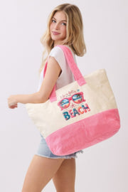Side view of a model showcasing the Life Is Better At The Beach Tote Bag by HD ACCESSORIES. The stylish pink and cream tote is perfect for carrying beach essentials, making it a trendy addition to any summer outfit. Great for accessories, handbags, and new arrivals.