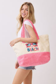 The model happily poses with the Life Is Better At The Beach Tote Bag from HD ACCESSORIES, illustrating its spacious design and fun beach theme. This tote is a fashionable choice for summer adventures and a fantastic accessory among handbags and new arrivals.